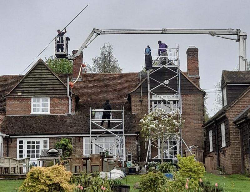 The Roof Moss Cleaners using cherry picker and scaffolding to clean roof safely and professionally in Aldershot, Hampshire