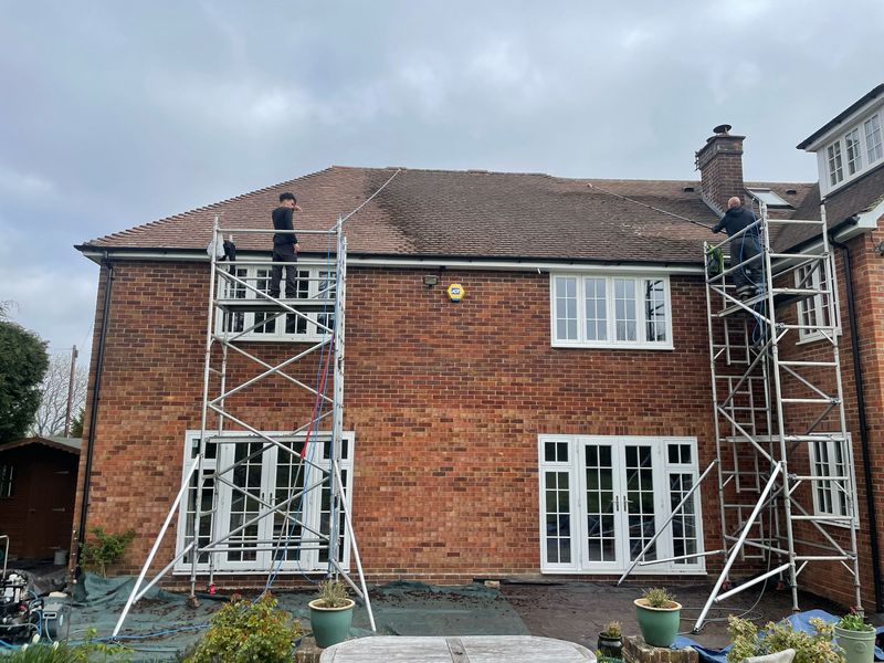 Roof cleaning carried out safely from scaffold towers by The Roof Moss Cleaners in Aldershot